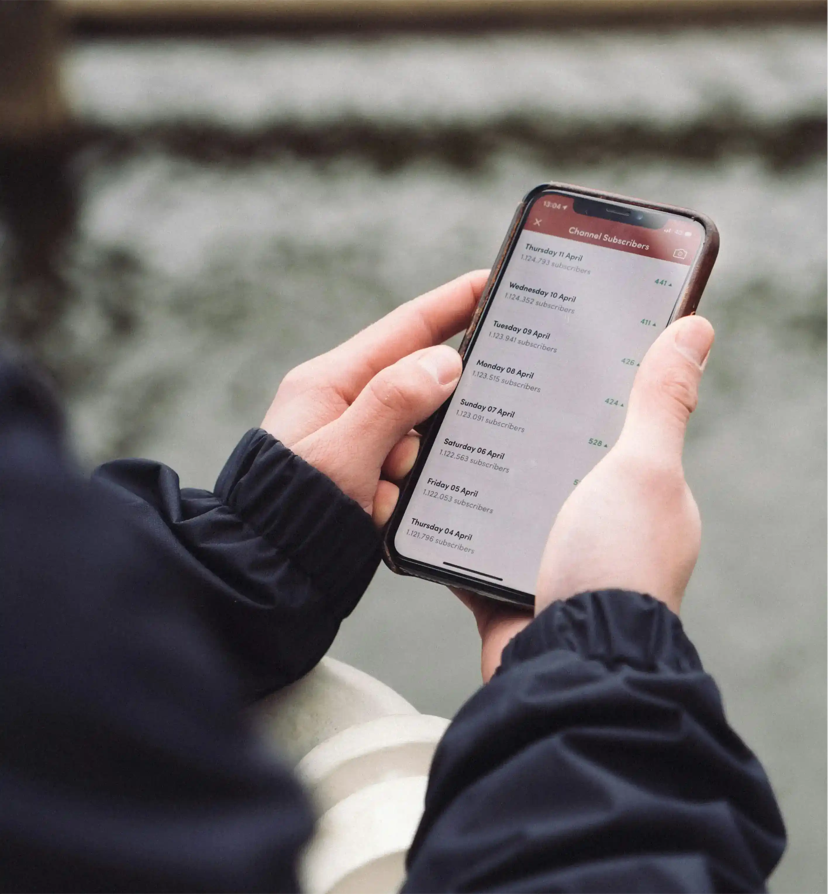 A seller scrolling through customer messages on a phone