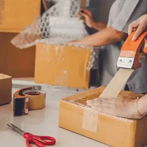 Packing a customer order into a taped box