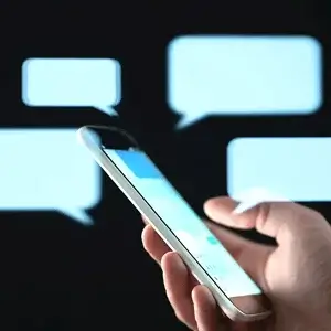 A buyer messaging a seller, chat bubbles floating around a phone